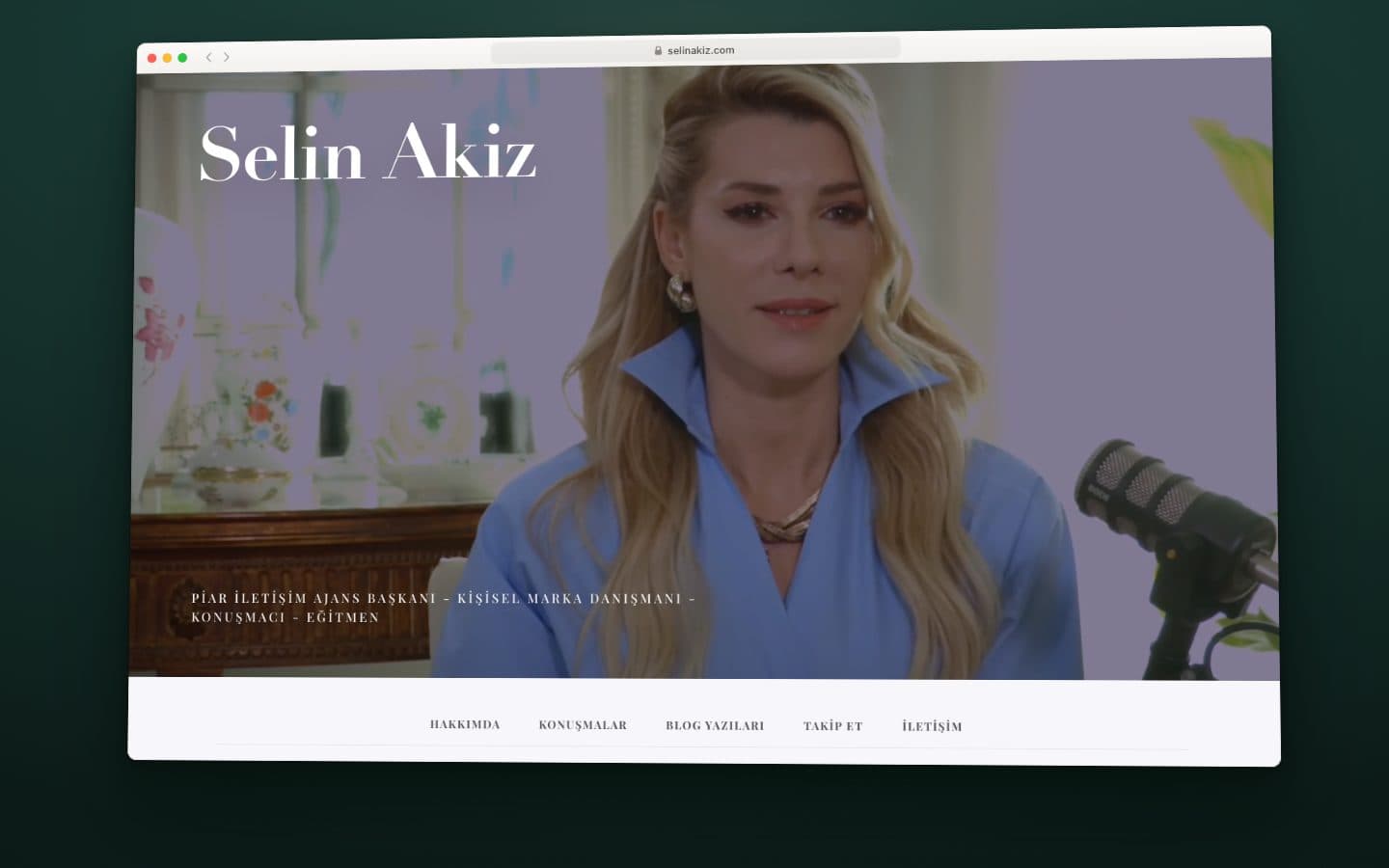Still from the screen recording of the selinakiz.com home page: the video header with her name and titles, above the menu