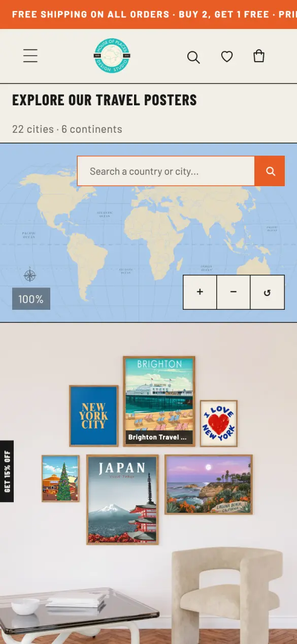 The home page on a phone: announcement bar, logo and menu, a world map with a search box, and a framed-poster wall photo.