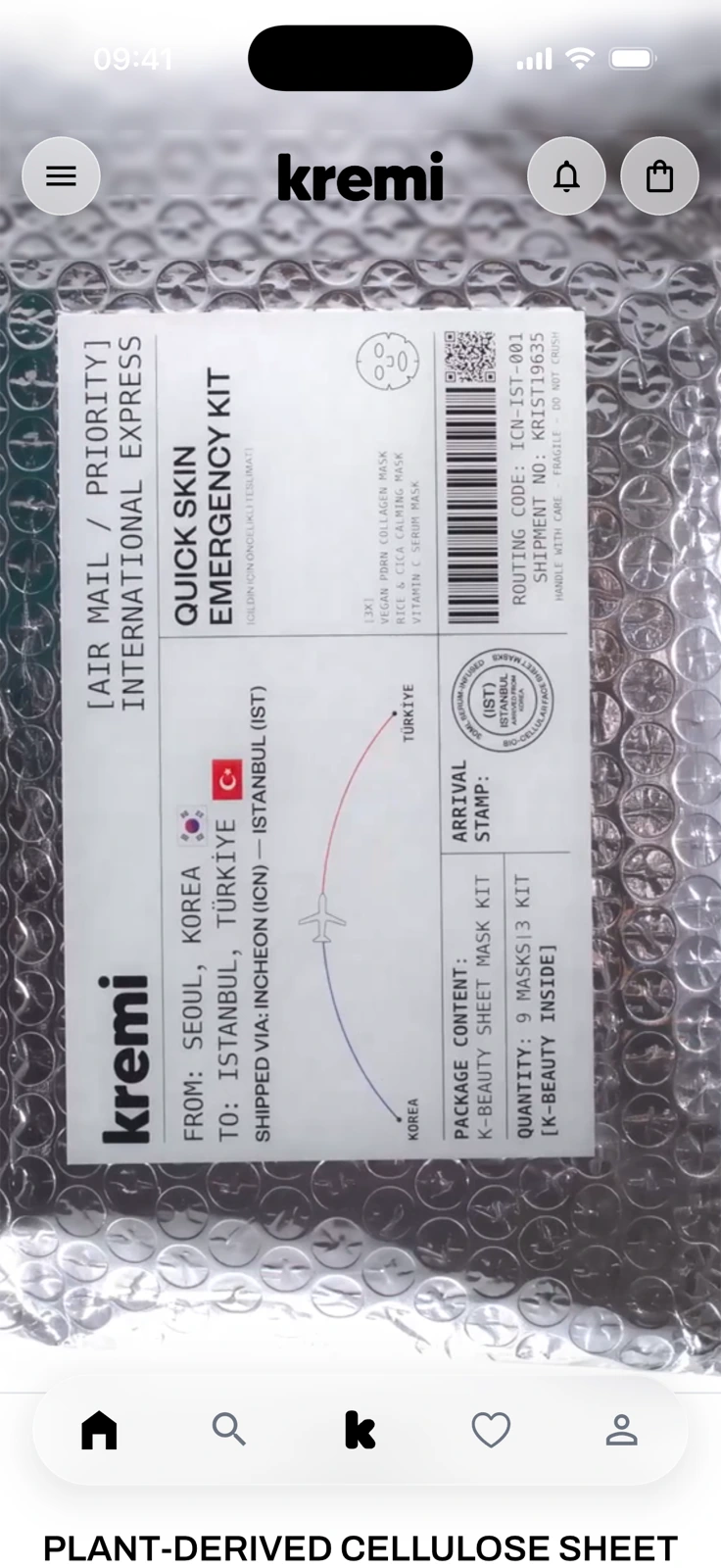 The Kremi app home screen: a full-height brand video showing a sheet-mask kit in bubble wrap under the kremi header, with menu, bell and bag buttons, and a five-icon tab bar at the bottom.